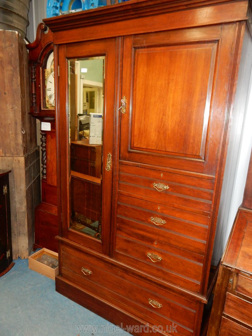 An Edwardian Mahogany Wardrobe with a bevelled mirror door,