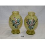 A pair of mottled green glass vases with applied flowers, 6'' tall.