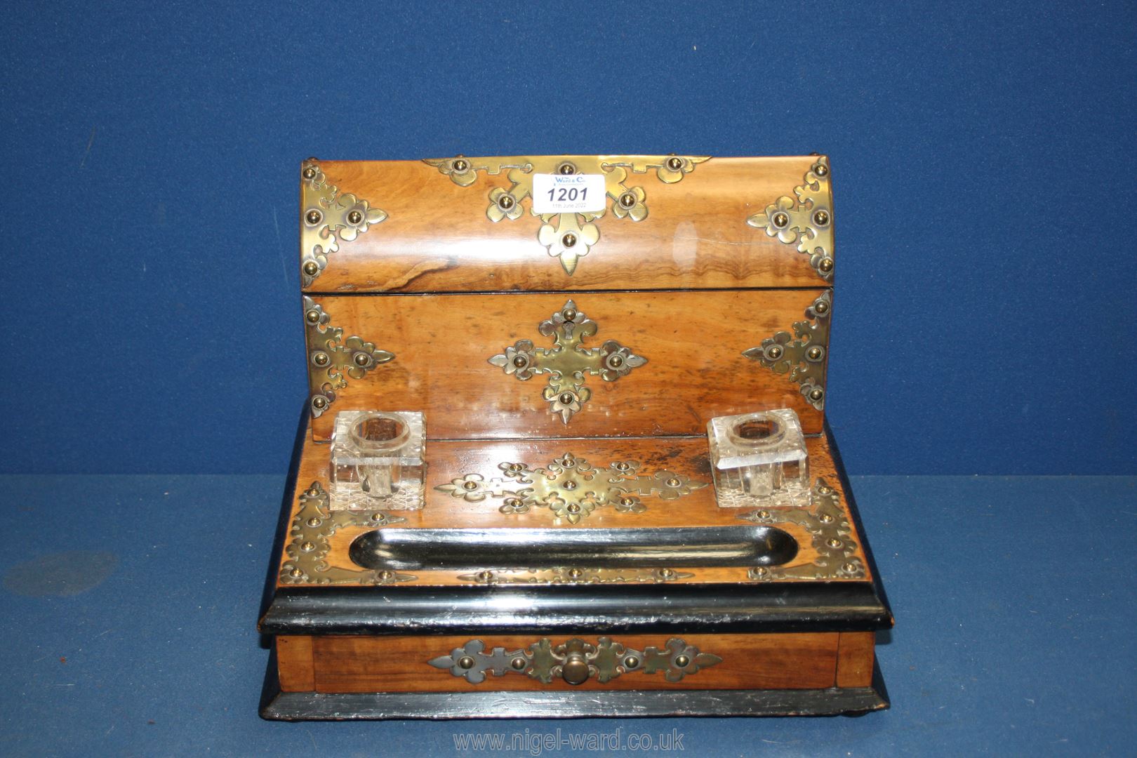A walnut veneered table top Stationery Box with ornate brass embellishment,