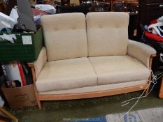 A beige upholstered Ercol two seater Settee.