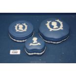 Three pieces of dark blue Wedgwood Jasperware including 3 candy pots and lids commemorating the