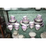 An unusual Doulton series ware Teaset with vivid purple sunset over a woodland scene comprising