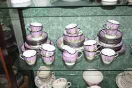 An unusual Doulton series ware Teaset with vivid purple sunset over a woodland scene comprising