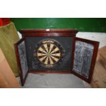 An Edwardian mahogany dartboard cabinet with chalk slate markers, with Winmau dartboard,