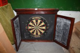 An Edwardian mahogany dartboard cabinet with chalk slate markers, with Winmau dartboard,