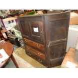 A darkwood stained Jacobean panelled Tallboy cupboard over three graduated drawers,