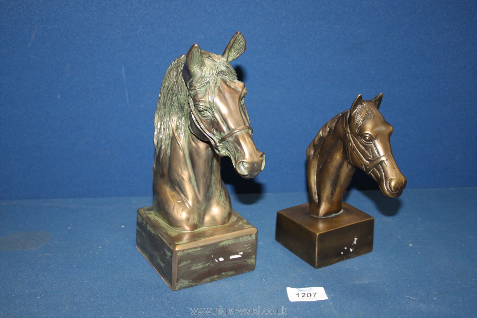 A Past Times bust of a horses head and smaller similar one in cast metal, 10" tall and 7 1/2" tall.