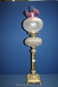 A double burner Oil Lamp on tall column with cut glass reservoir,