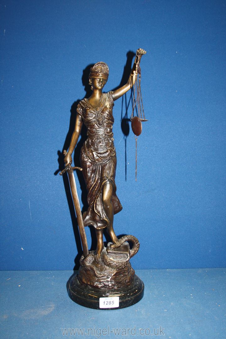 A cast figure of ''Blind Justice'' in the form of a blindfold woman with a scales in her left hand