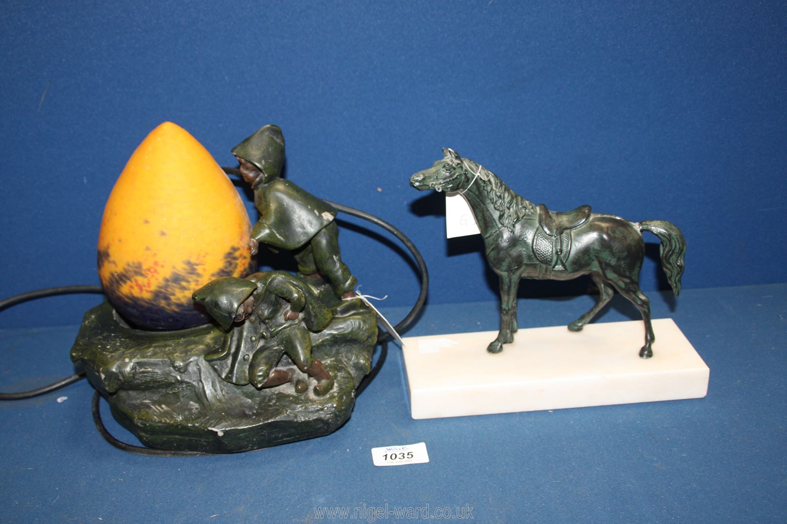 An Auguste Moreau style lamp with orange egg shaped shade featuring children playing on a rock,