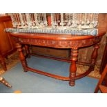 A Mahogany Side/Serving Table of "D" shape having a carved scroll decorated frieze and standing on