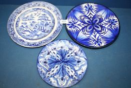 Two blue and white faience plates and a willow plate.