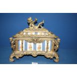 A decorative cast metal Casket/Box, with gilt cherubs to the corners,