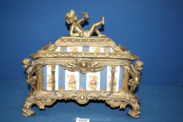 A decorative cast metal Casket/Box, with gilt cherubs to the corners,