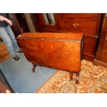 An unusual Walnut Sutherland Table having turned supports and brass castors,