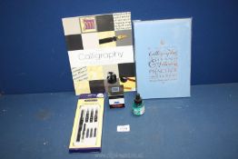 A Calligraphy set with unopened pen, practise notepad and two bottles of ink .