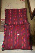 A pair of vintage handmade Afghan saddle bags, made up as cushions for conservatory or sofas,