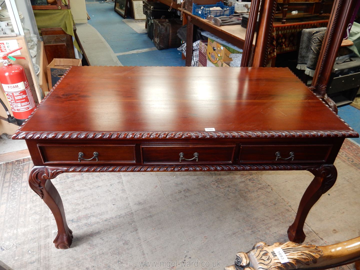 A rectangular Library/Writing Table having rope-like edging and standing on carved cabriole legs