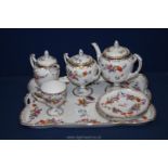 A Dresden style Tea for One set complete with footed teapot, cup, jug and sucrier with lid,