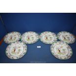 Six old Mason's plates with pink and pale orange blooms and pale green foliage.