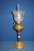 A single burner brass column Oil Lamp with brass reservoir, glass shade and chimney,