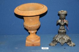 A small very heavy cast metal urn shaped planter and black cast metal candlestick with Ivy and