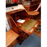 A compact contemporary ''Reprodux'' serpentine fronted Mahogany Bureau standing on bracket feet,