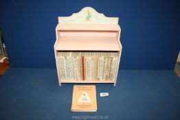 A complete set of Beatrix Potter books and shelf.