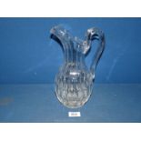 A good quality cut glass water Jug in ewer style with thumb cut detail, 11'' tall.