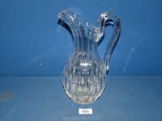 A good quality cut glass water Jug in ewer style with thumb cut detail, 11'' tall.