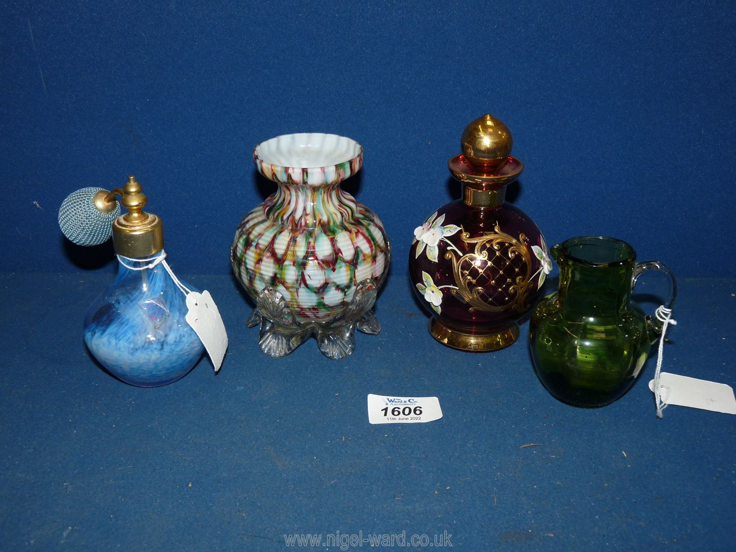 A cranberry coloured scent bottle with applied gilt and porcelain decoration,