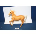 A Beswick Palomino horse, leg a/f, 7'' wide x 7'' tall.