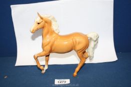 A Beswick Palomino horse, leg a/f, 7'' wide x 7'' tall.
