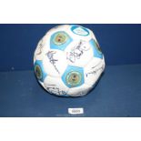 A Manchester City Football signed by many celebrities including Alex 'Hurricane' Higgins.