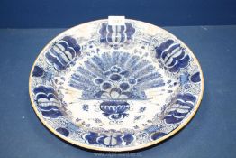 A large Delft earthenware dish, some chips to rim, 13 3/4" diameter.