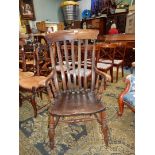 A solid Elm seated Windsor Armchair.