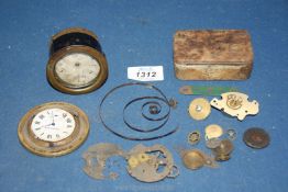 A box of vintage clock components.