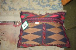 A cushion made from a fine Sumak rug, 23'' x 17''.