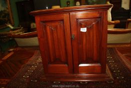 A wooden Smokers Cabinet with two interior shelves and three drawers,