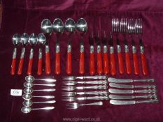 A quantity of cutlery including pastry knives and forks, coffee spoons, etc. some with red handles.
