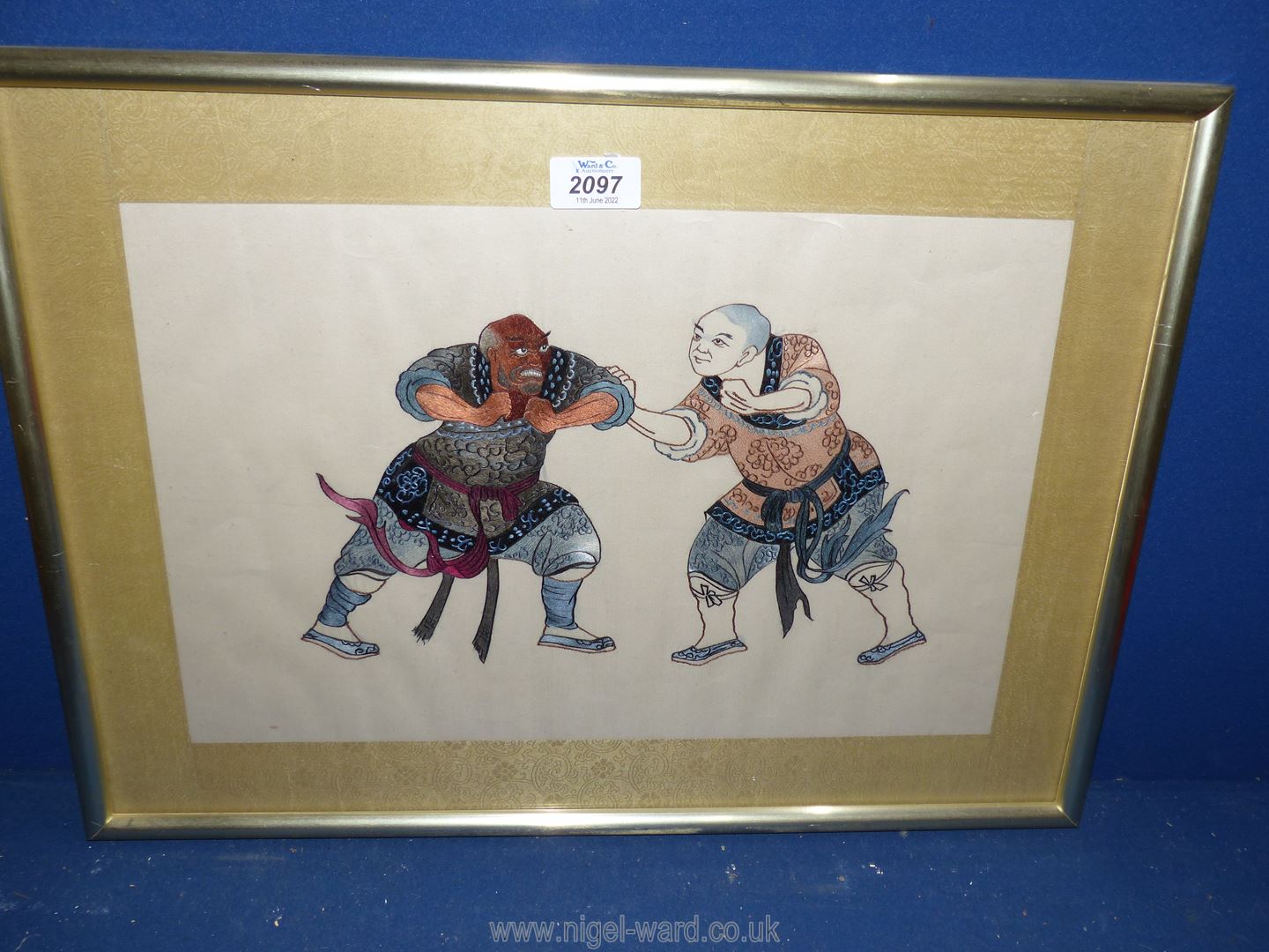 An Oriental embroidery of wrestlers.
