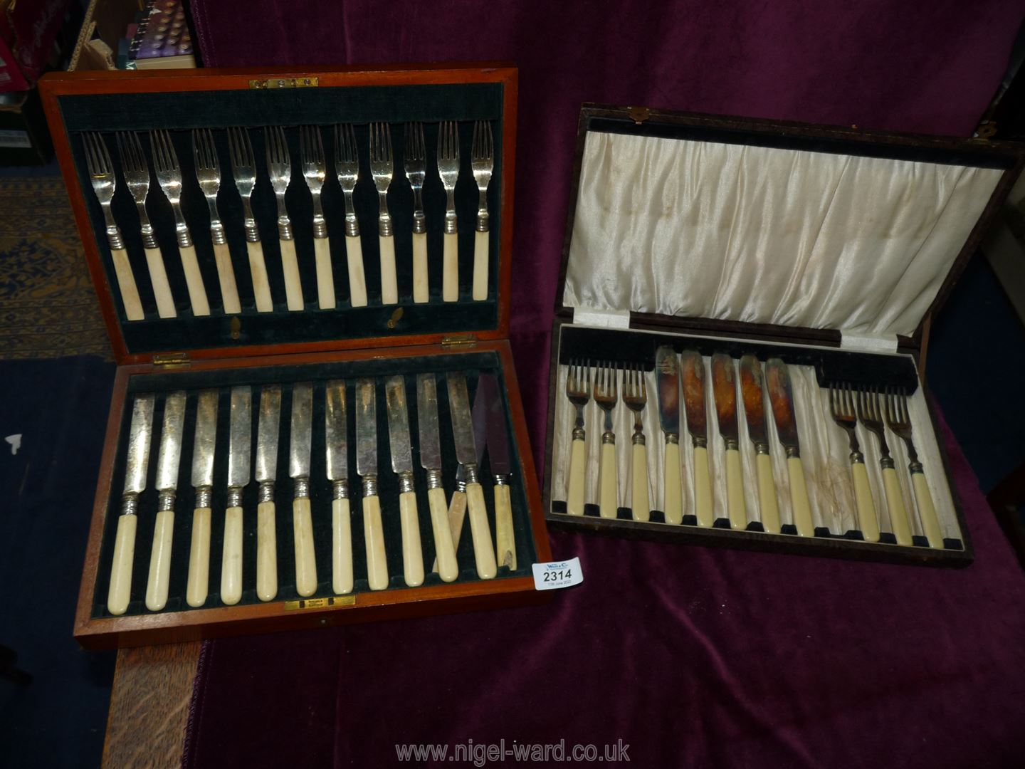 A cased set of bone handled knives and forks and a cased set of Fish Eaters, (one knife missing).