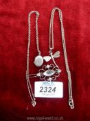 A silver dragonfly pendant and chain, stamped 925, an oval locket and chain,