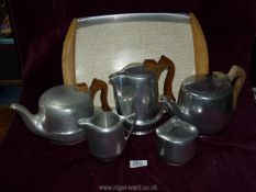 A Picquotware teapot, sugar bowl, milk jug and tray.