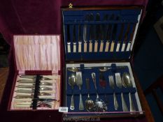 A wooden canteen of mixed cutlery including knives, forks, spoons, teaspoons etc.