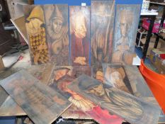 A quantity of paintings on wood depicting figures in various poses,