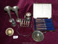 A box of silver plate items including toast rack, trophy, boxed knives etc.