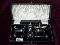 A cased Walker & Hall plated Cruet complete with blue glass liners and spoons.