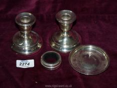 A small quantity of Silver including a pair of weighted candlesticks (1956),