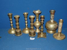 A small quantity of brass candlesticks and two engraved vases.